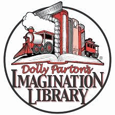 A row of books, spines out, between two train bookends, resting on an open book. The caption reads Dolly Parton's Imagination Library